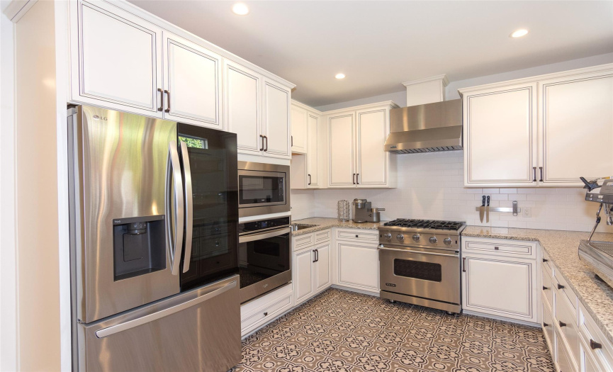 Stainless appliances include Viking gas range & hood, additional built-in oven & microwave & dishwasher