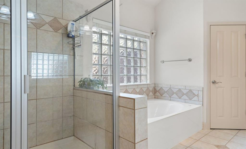 Within the main suite bathroom, you'll find both a spacious walk-in shower and a relaxing garden tub, offering you the choice of a quick rejuvenating shower or a leisurely soak in the tub.