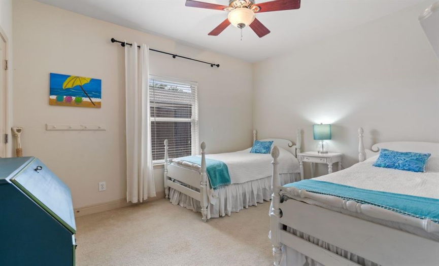 The three spacious guest bedrooms boast an abundance of natural light streaming in through large windows, creating a bright and airy ambiance.These rooms also feature ceiling fans to ensure optimal comfort, and their high ceilings lend an even greater sense of spaciousness.