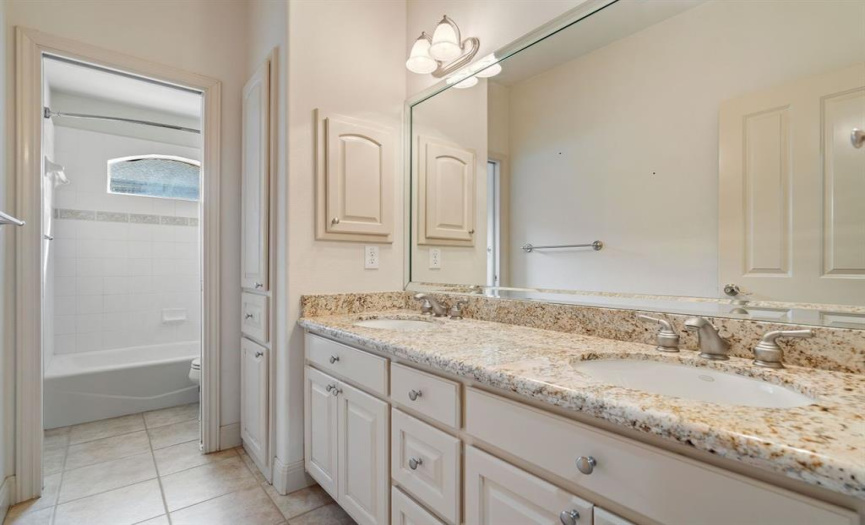 The guest bathroom boasts a spacious double vanity, providing ample space for you and your guests to prepare for the day ahead. 