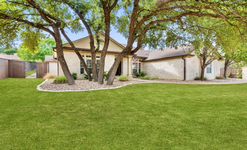 Welcome to this enchanting single-story home, nestled in the heart of Old Lakeway, where the charm of yesteryears meets the allure of modern living. Photo from listing with green grass.