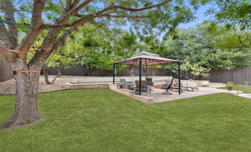 Pet owners, rejoice! Your four-legged companions will adore this backyard. There's plenty of room for them to romp, chase their favorite toys, or simply bask in the sun. The secure fencing ensures their safety while they enjoy their own slice of outdoor heaven.