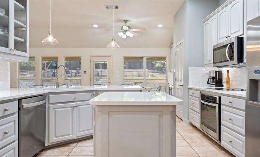 Adorned with gleaming stainless steel appliances and featuring a convenient built-in desk, this kitchen is as tasteful as it is practical. 