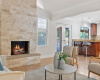 As the day comes to an end, gather around the charming limestone gas fireplace in the living area. 