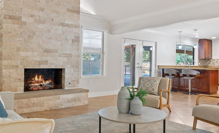 As the day comes to an end, gather around the charming limestone gas fireplace in the living area. 