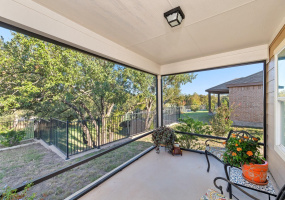 Enjoy the peaceful yard from the screened back porch.