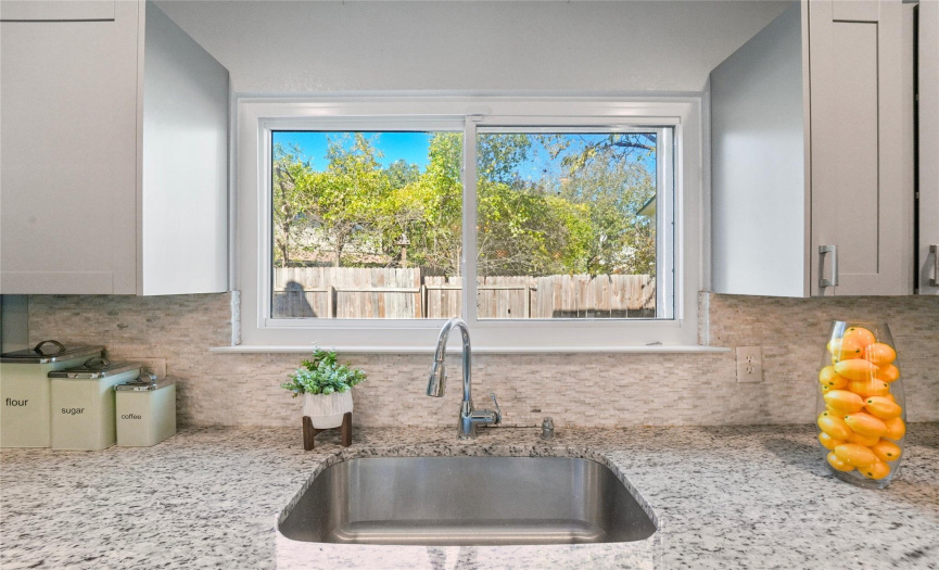 Enjoy serene views of the surrounding shade trees right from the kitchen window. 