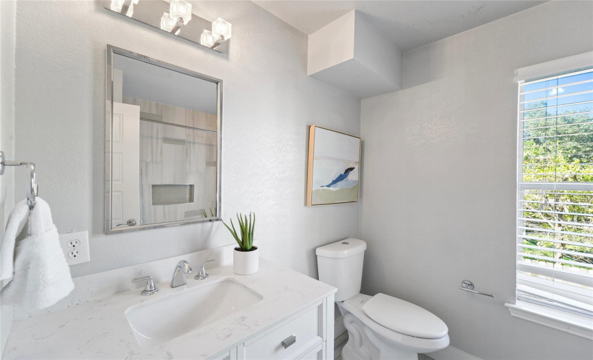 The full secondary bathroom has also been tastefully updated and features a stylish contemporary vanity with quartz countertop. 