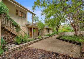 Custom built home with miles of views all the way to Steiner Ranch.  Two sets of stairs in this hill country floor plan, kitchen, dining, living up, bedrooms down.  One set outside front, the other inside living room.