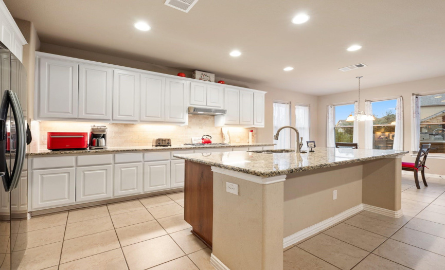 Unleash your inner chef in this well-equipped kitchen, where culinary masterpieces come to life with a spacious center island and modern appliances
