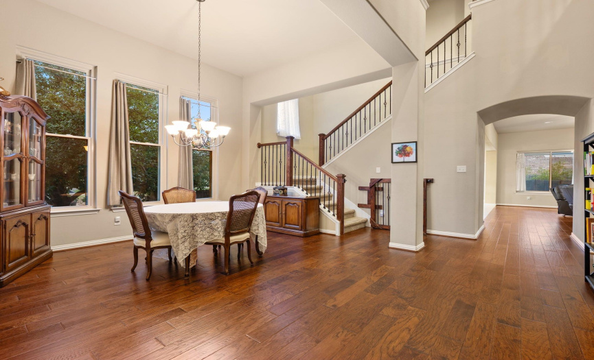 As you enter, be greeted by high ceilings in the entryway and warm wood flooring, creating an atmosphere that feels like home