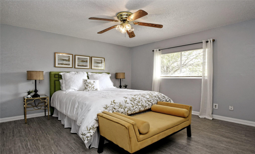 One of two lovely secondary bedrooms with tasteful neutral paint and wood trim baseboards. 