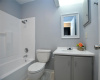 The full secondary bath offers a single vanity with a resurfaced countertop and a shower/tub combo. 