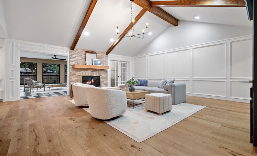 Spacious family room with vaulted beam ceilings and a fireplace.