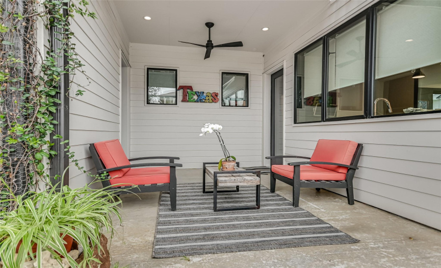 The rear patio overlooks the beautifully landscaped side yard.
