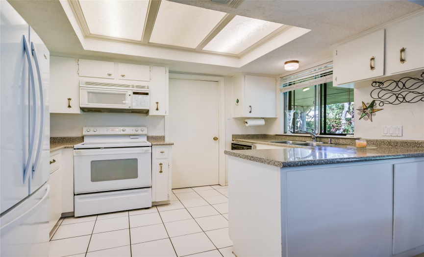 The well-laid-out kitchen opens to the family room.