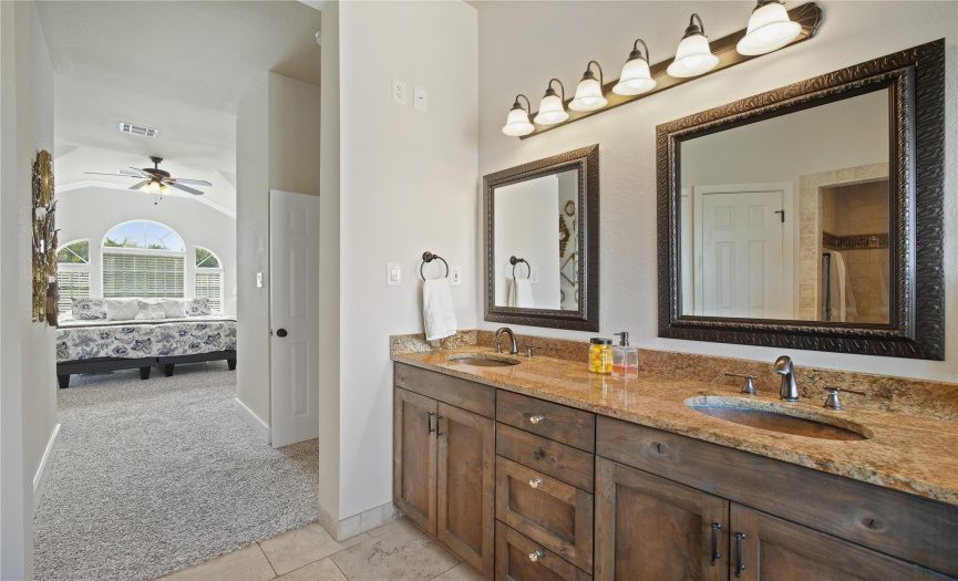The en-suite bathroom features dual vanities, garden tub, walk in shower and oil-rubbed bronze fixtures.