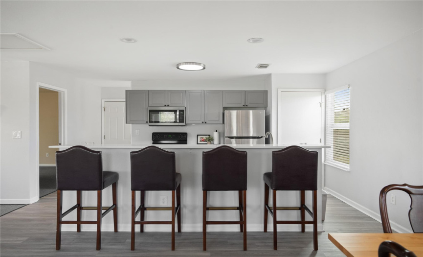The garage apartment's kitchen was renovated in 2022, and features a breakfast bar at the island.