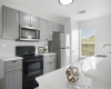 Gray cabinets and white quartz countertops were installed in 2022.