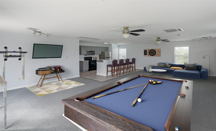 Garage apartment, virtually staged as game room.