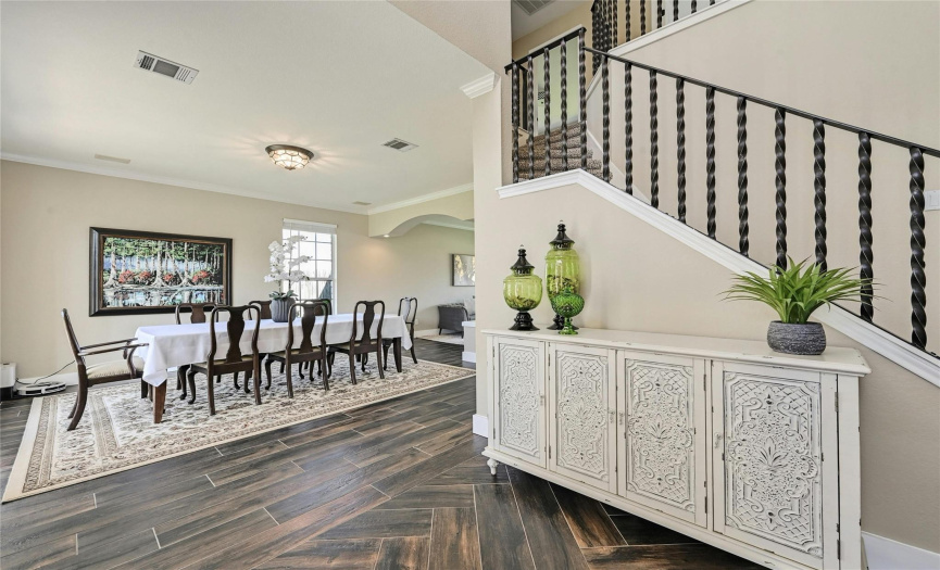 The entryway with soaring ceilings opens into the formal dining room.