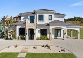 Welcome to this exquisite residence crafted by Texas Artisan Builders, a modern gem nestled in the prestigious lakeside enclave of Waterside Estates in Rough Hollow.