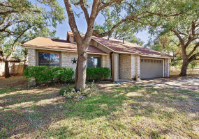 Large trees surround this four bedroom, two bath home zoned for Round Rock ISD schools.