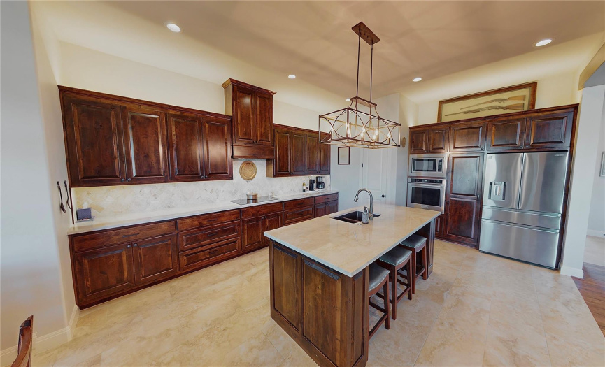 Kitchen features stainless appliances, solid wood cabinets, under cabinet lighting, pantry and tons of storage!