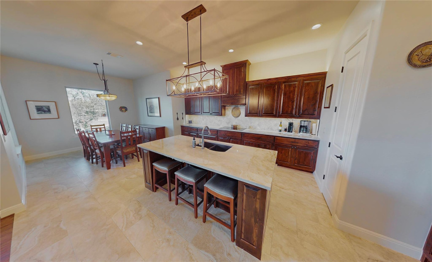 Kitchen with large eat-up island and spacious dining area.