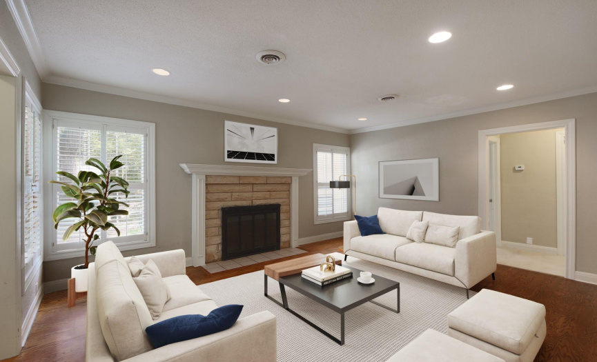 Virtually Staged. The living room offers recessed lighting, crown molding, plantation shutters and inviting fireplace