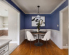 Virtually Staged. Elegant dining with wainscoting and crown molding