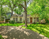 Inviting facade, convenient circle driveway and gorgeous shade trees