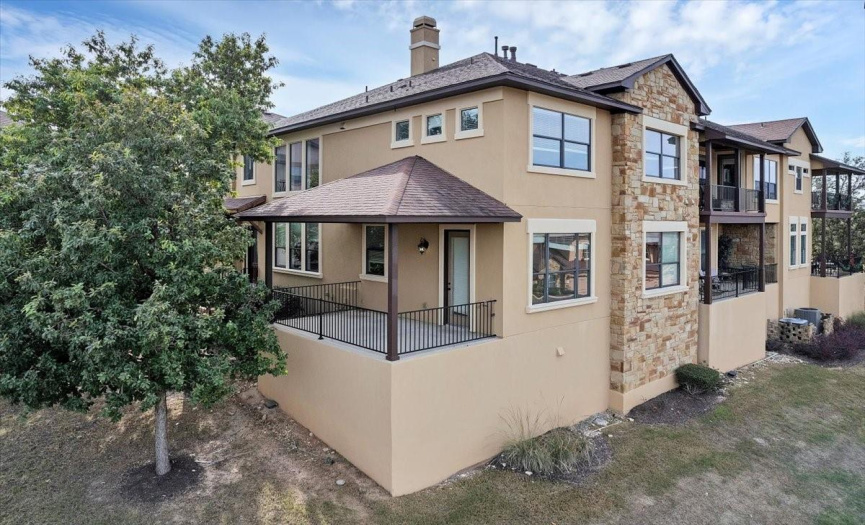 The spacious covered patio has both greenbelt and Hill Country views!