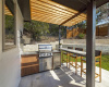 Outdoor kitchen with bar-height counter.