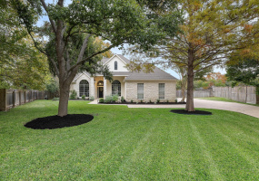 Stately curb appeal with this Austin limestone sprawling one story home!
