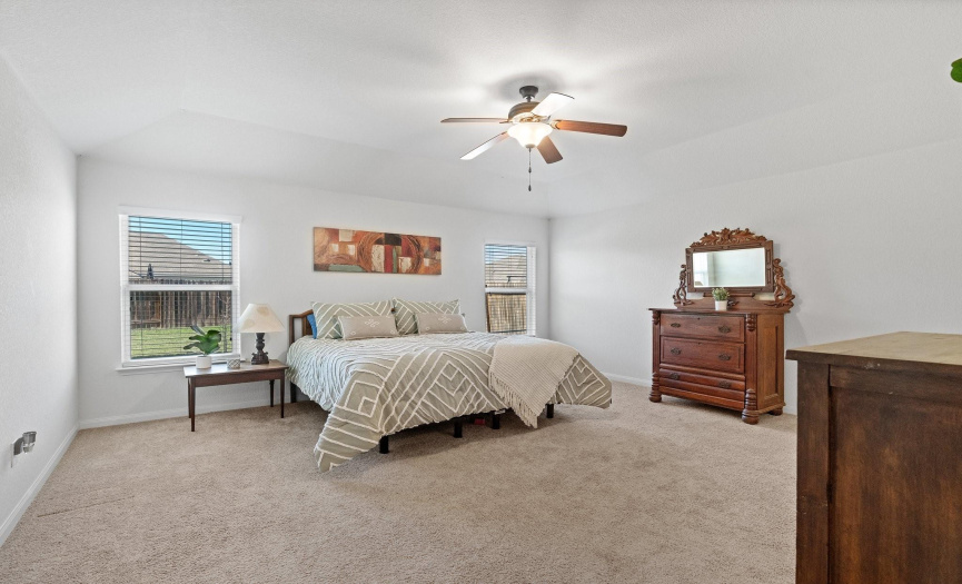 Escape to your private sanctuary in the primary bedroom, complete with a vaulted ceiling.