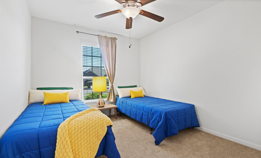 The fourth bedroom, featuring a comfortable space for relaxation or creative use.
