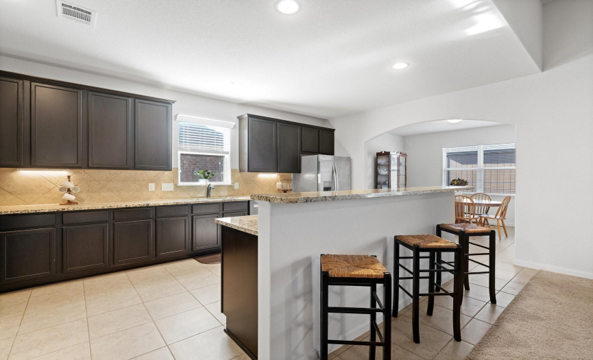 The kitchen is a chef's delight, featuring a center island and a convenient breakfast bar, where guest can sit and mingle.