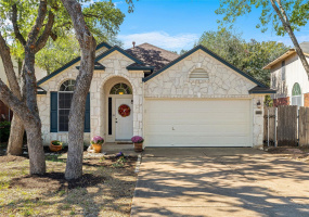 Lovely Austin Stone 3 bedroom 2 bath home with 2 living areas offers a multitude of trees front and back located on a quiet cove.