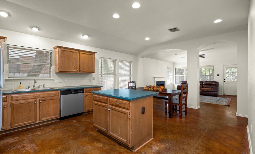 The natural wood cabinets create a warm kitchen open to the dining area and the family room.