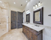Luxury continues in the primary bath with dual vanities, deep soaking tub and walk-in shower with custom tile work. 
