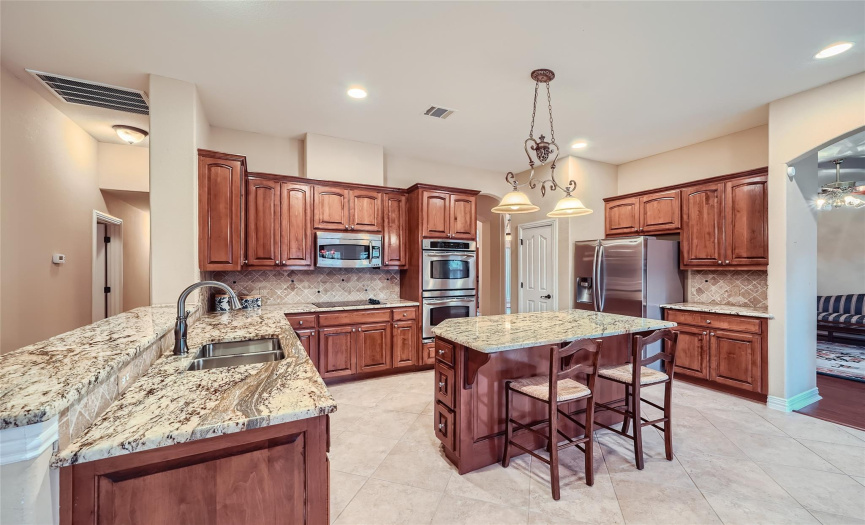 large kitchen that flows well with granite counters
