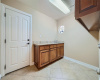 Extremely functional laundry room with granite counters ample storage and a SINK! 
