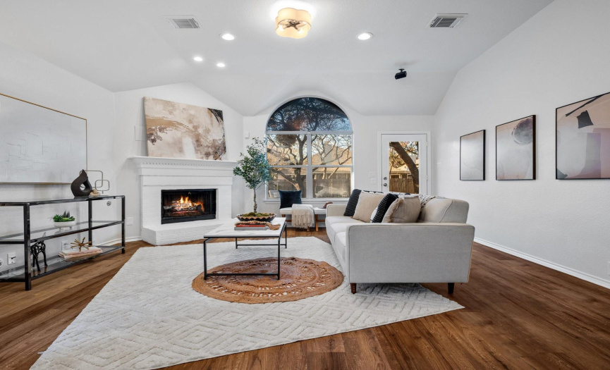 Sleek design elements, recessed lighting, and a corner fireplace create an inviting ambiance