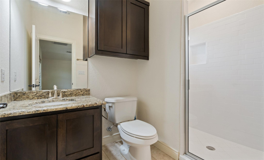 Freshen up in the well-appointed upstairs guest bathroom, complete with a walk-in shower.