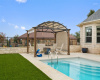 The backyard is a private retreat with a sparkling in-ground pool.