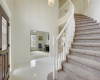 Entry foyer with sweeping stairs, high ceiling, chandelier entry.  To the left formal living, or music room.