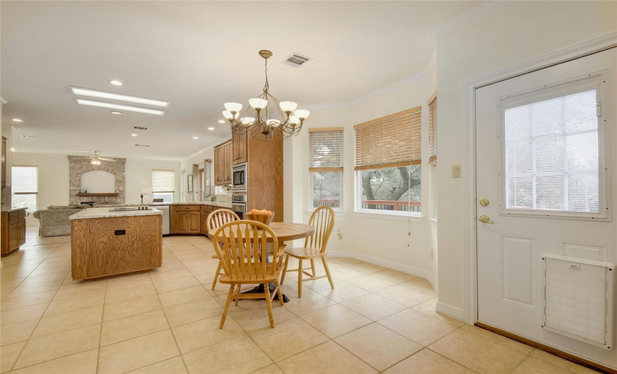 Kitchen with eat-in option, bay window feature on tile flooring. Open, airy, and ready for you.