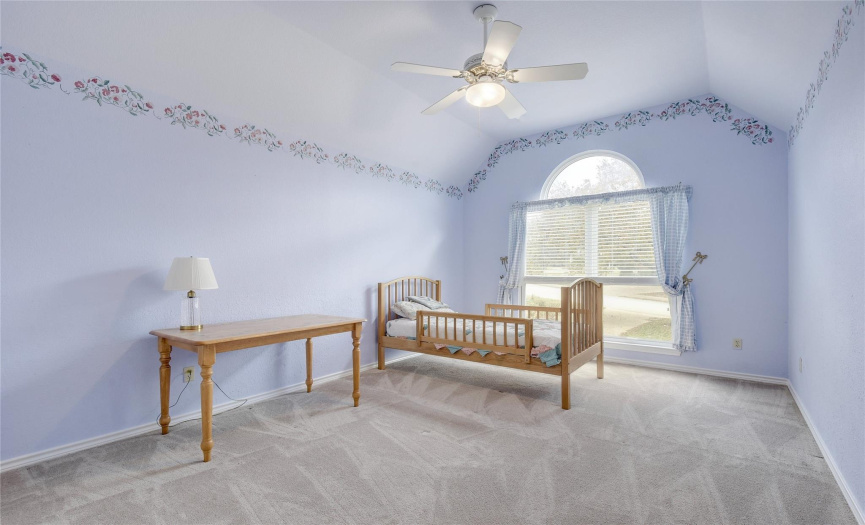 Fourth bedroom with charm for the princess in your household.  Window treatments match the colorful, whimsy of the room.