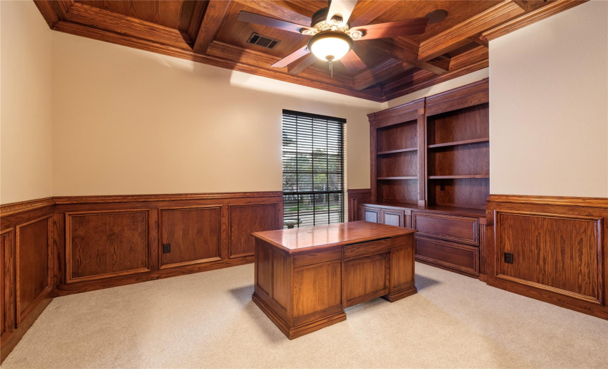Dedicated office with beautiful wainscoting and built-in shelving